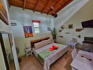 a bedroom with a bed with a red bow on it at BellaVista Suites By Villas Verdes - Samara Beach in Sámara