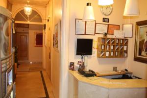 a hallway with a desk and a computer on a wall at Hostal Santa Cruz in Madrid