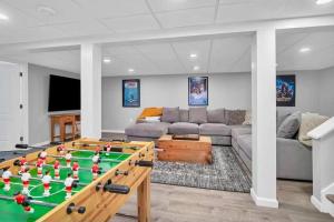 a living room with a pool table and a couch at Lucky 8 Camp Cozy Coastal Retreat with Hidey Hole & Family Charm in Waterford