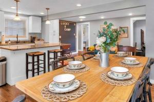 a dining room and kitchen with a wooden table and chairs at Lucky 8 Camp Cozy Coastal Retreat with Hidey Hole & Family Charm in Waterford