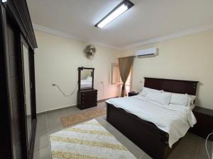 a bedroom with a large bed and a mirror at Charming Chalet with Stunning Sea View & Private Garden in Coral Hill Resort, North Coast Egypt in Zāwiyat al ‘Awwāmah +30 photos