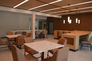 a dining room with tables and chairs in a room at Wingate by Wyndham College Station South in College Station