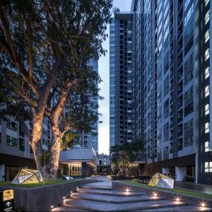 a walkway in the middle of a city with tall buildings at The Base Central Pattaya Super condo in Pattaya Central