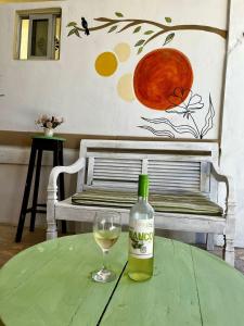 a bottle of wine sitting on a table with a glass at Recanto Canoa - Canoa Quebrada in Aracati +39 photos
