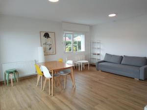 a living room with a couch and a table and chairs at Mar de Queiruga: 11 Illa do Mar in Porto do Son
