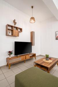 a living room with a flat screen tv on a wall at Modern Apartment in the heart of Kos Town in Kos Town