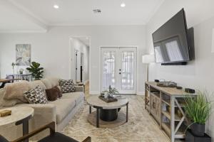 a living room with a couch and a tv at Piney Cove Retreat in West Monroe