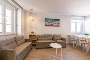 a living room with a couch and chairs and a table at Blue Door Algarve - Guest House in Portimão
