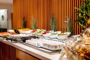 a buffet with bowls of food on a table at Flamingo Beach Mate in Adeje