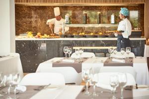 a restaurant with a chef preparing food in the kitchen at Flamingo Beach Mate in Adeje