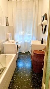 a bathroom with a tub and a toilet and a sink at Spacious, minimalist, chic "Maison de Fleurs" in Malgrate +24 photos