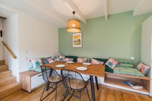 a living room with a table and a couch at Charmante Maison sur le port Loguivy de la Mer in Ploubazlanec