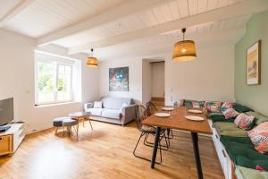 a living room with a couch and a table at Charmante Maison sur le port Loguivy de la Mer in Ploubazlanec
