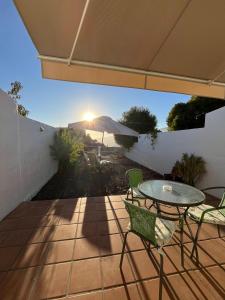 a patio with a table and chairs and an umbrella at CRÁTER 2 in El Paso +6 photos