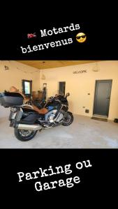 a motorcycle parked in a garage with the words performance on garage at Le QG chez Flo et David in Saint-Julien-Molin-Molette