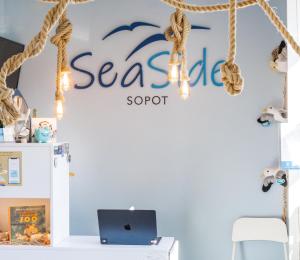 a room with a sign for a seafood store at SeaSide Sopot - butikowe noclegi przy plaży in Sopot