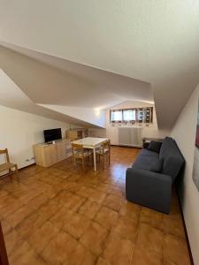 a living room with a couch and a table at Casa Laura in Porto Garibaldi