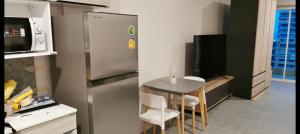 a kitchen with a stainless steel refrigerator and a table at Super View in Pattaya South