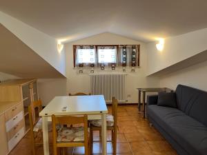 a living room with a couch and a table at Casa Laura in Porto Garibaldi