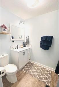 a bathroom with a white toilet and a sink at Cici's Guest House in Laurel +29 photos