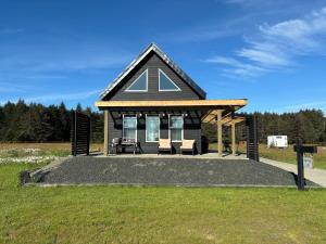 a small house with a large letter a on it at Sunrise Cabin- The Loft - secluded Beach front guest house in Sandspit