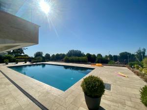 a swimming pool in the middle of a yard at LittleBalaton- Pool, sauna in Alsóörs