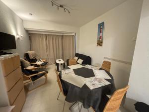 a living room with a dining room table and chairs at Monte-Carlo in Koksijde