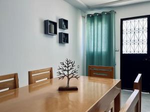 a dining room with a table with a tree on it at Cozy Family House in City-Center in Chefchaouene