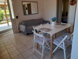 a table and chairs in a living room with a couch at Dimitra House in Metamorfosi