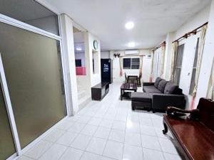 una sala de estar con un sofá y una mesa en K T Greenvill, en Ban Khom