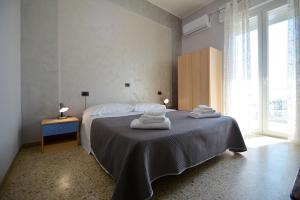 a bedroom with a bed with towels on top of it at Hotel BELLA ROMAGNA in Casal Borsetti