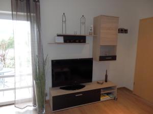 a living room with a flat screen tv on a table at Ferienwohnung Reichmann in Olpe