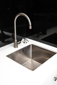a kitchen sink with a faucet on a counter at Guesthouse - 3 room in Sumqayıt +48 photos