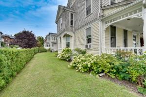 a house with a yard with white flowers at Charming Victorian Retreat with Hudson River Views in Newburgh
