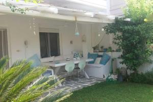 a patio with a table and chairs in a yard at Any Summer garden house in Skála Nikíta