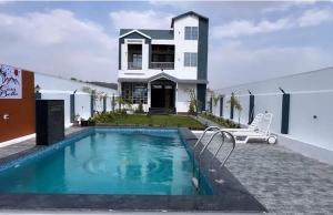 a house with a swimming pool in front of a house at Casa bella a beautiful house in Chittaurgarh