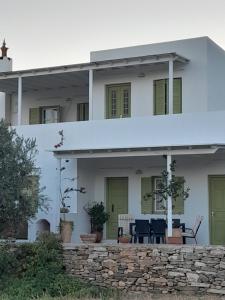 a white house with a stone wall at Villa Simeon in Platis Yialos Sifnos
