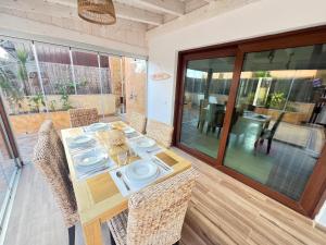 a dining room with a table and some chairs at Tinajas Penthouse Views in Corralejo