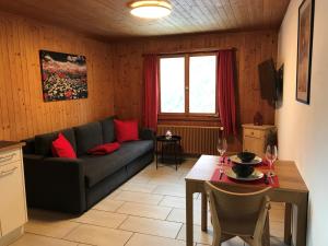 a living room with a couch and a table at Bergesrueh in Malix
