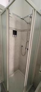 a shower with a glass door in a bathroom at Casa Francesca: un mare di relax! in Ventimiglia +21 photos