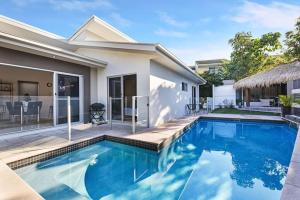 a swimming pool in front of a house at TWELVE at 12 Private Central Maroochydore in Maroochydore