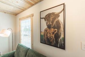 a picture of two cows hanging on a wall at #StayinMyDistrict Brussels Bungalow in North Bend