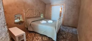 a small bedroom with a bed and a staircase at La Dimora dellaZingara in Statte