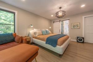 a bedroom with a bed and a couch at Beach Glass Retreat - Pickleball, Lake access 2 minute walk away, luxury home in Fennville