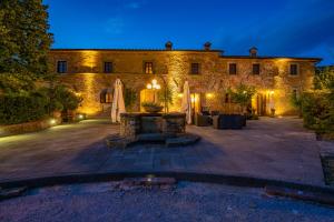a large stone building with a fountain in front of it at Villa Borgo San Pietro in Cortona
