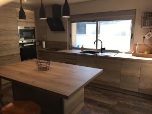 a kitchen with a wooden counter top and a sink at Villa SChic in Marseille