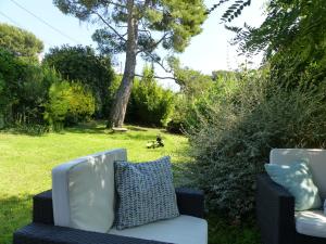 a blue and white couch sitting in the grass at Villa SChic in Marseille