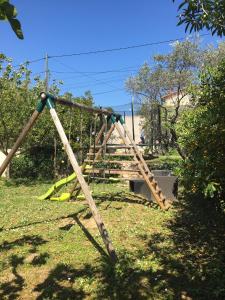 an old swing set in a park with a tree at Villa SChic in Marseille +2 photos