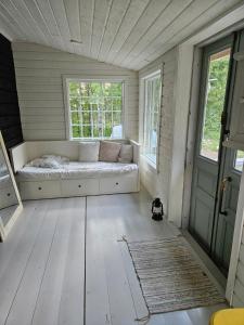 a room with a bench in a room with two windows at Kieloranta in Kuopio +15 photos
