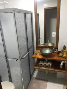 a bathroom with a sink and a mirror at Apartamento encantador em bairro Nobre. in Santa Cruz do Sul